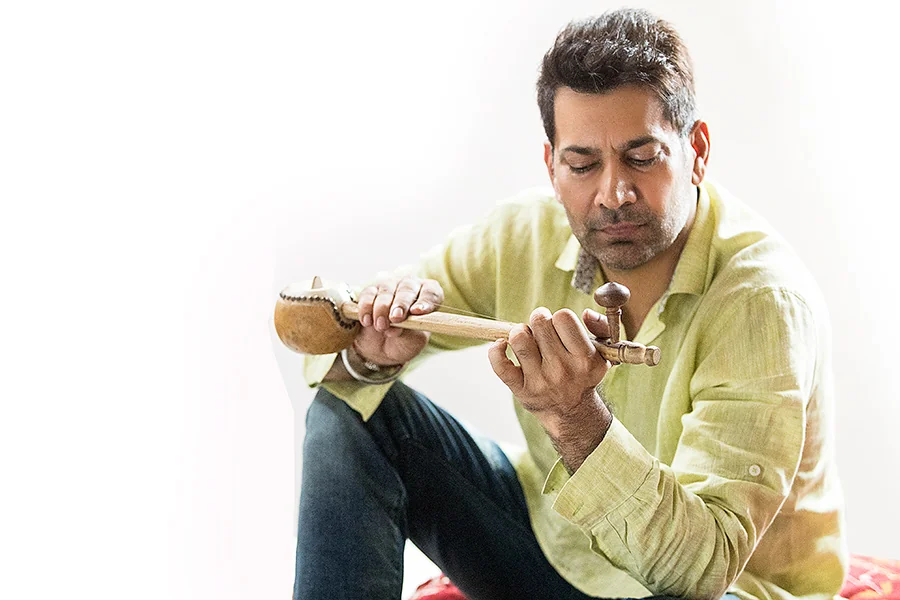 Jasbir Jassi playing a traditional musical instrument